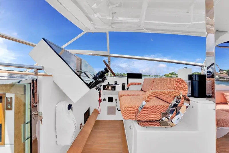 Slide: The Image of 2023 Delta Powerboats 60 Open helm with modern controls and patterned seating. - 24
