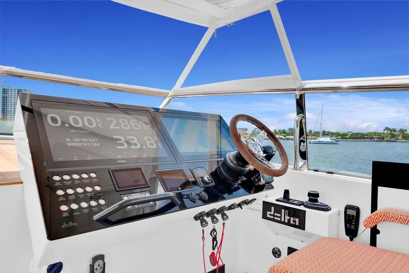 Slide: The Image of 2023 Delta Powerboats 60 Open helm with advanced navigation display and steering wheel. - 26