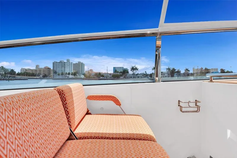 Slide: The Image of 2023 Delta Powerboats 60 Open interior with orange seating, cityscape view through windows. - 31