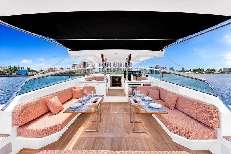 Slide: The Image of Luxurious 2023 Delta Powerboats 60 Open yacht interior with elegant dining setup and waterfront view. - 42