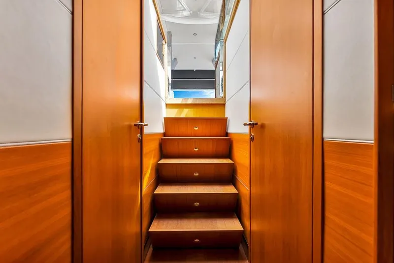 Slide: The Image of Interior staircase of 2023 Delta Powerboats 60 Open, featuring wooden steps and modern design. - 46