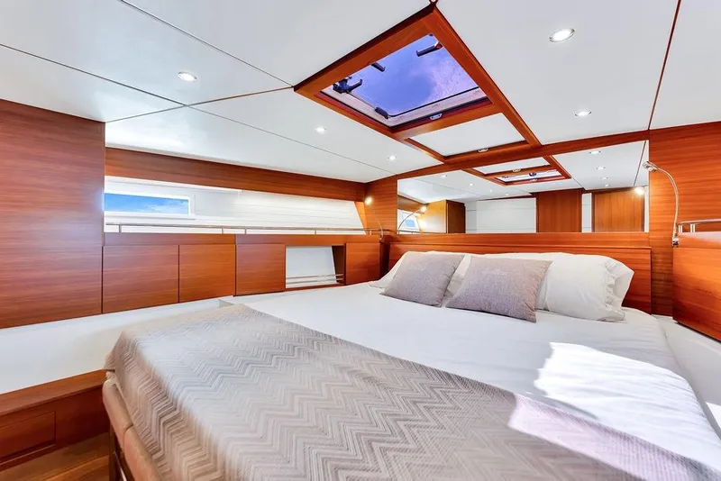 Slide: The Image of Luxurious cabin interior of 2023 Delta Powerboats 60 Open with skylights and elegant wood finish. - 50