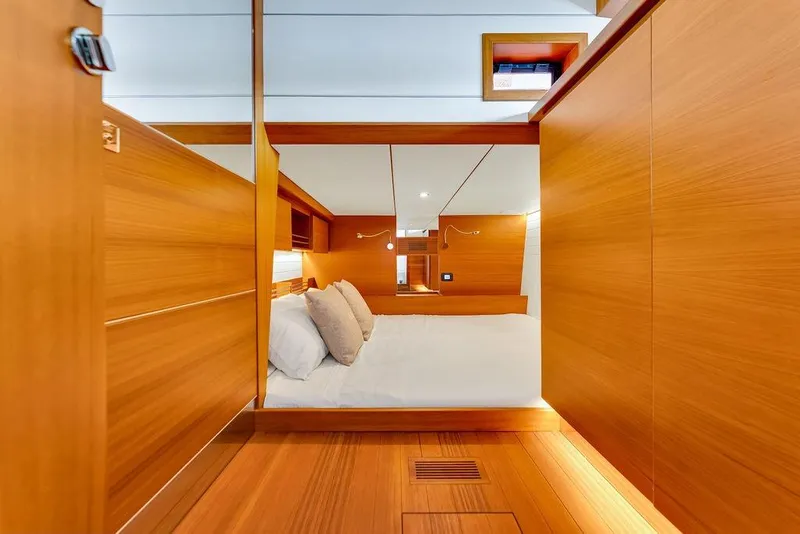 Slide: The Image of Luxurious cabin interior of 2023 Delta Powerboats 60 Open, featuring elegant wood paneling. - 60