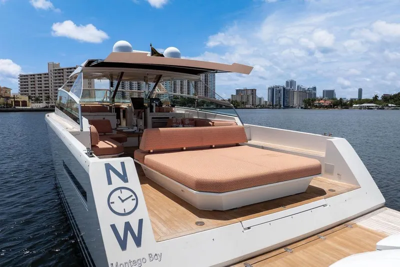 Slide: The Image of 2023 Delta Powerboats 60 Open yacht on water, city skyline in background. - 8
