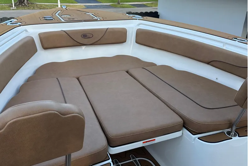 Slide: The Image of 2019 Sea Hunt Gamefish 25 boat interior with brown cushioned seating. - 10