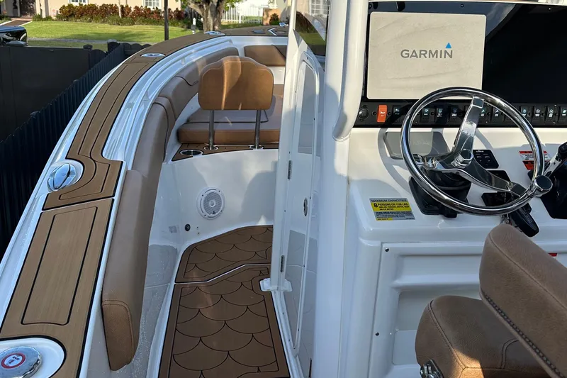 Slide: The Image of 2019 Sea Hunt Gamefish 25 boat interior with Garmin navigation system and stylish seating. - 2