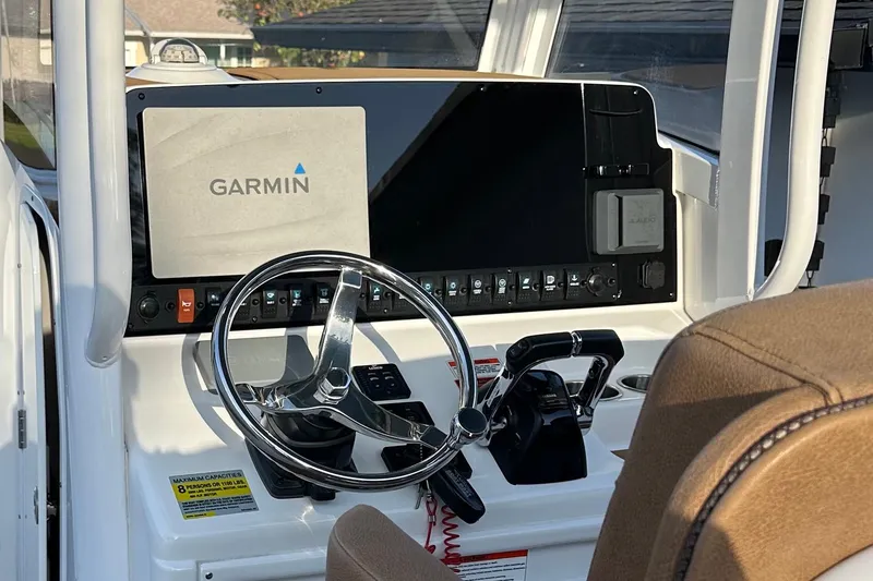 Slide: The Image of 2019 Sea Hunt Gamefish 25 helm with Garmin navigation system and steering wheel. - 3