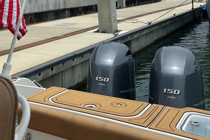 Slide: The Image of 2019 Sea Hunt Gamefish 25 with twin Yamaha 150 engines docked at marina. - 4