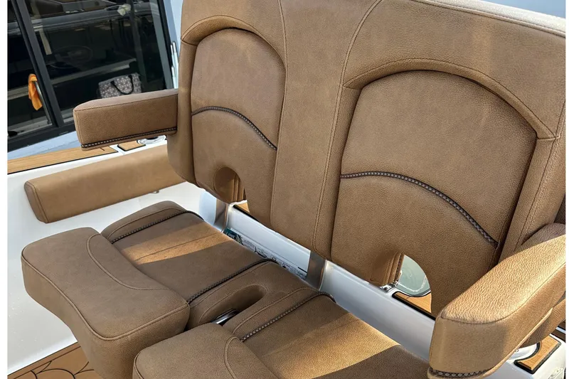 Slide: The Image of 2019 Sea Hunt Gamefish 25 boat seats with brown upholstery and armrests. - 8