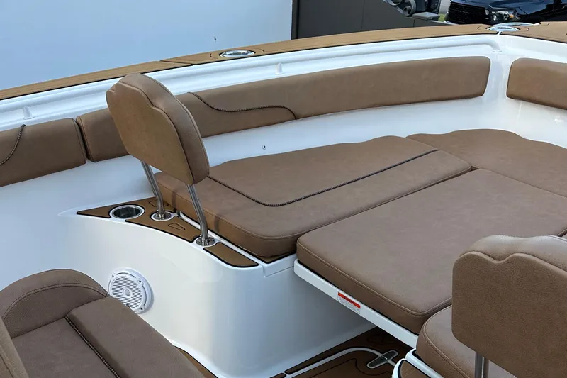 Slide: The Image of 2019 Sea Hunt Gamefish 25 boat interior with brown cushioned seating and cup holders. - 9