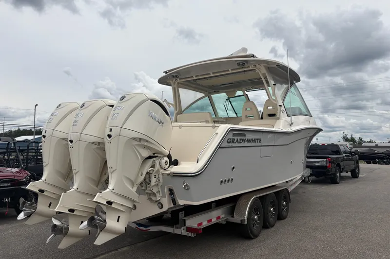 Slide: The Image of 2025 Grady-White Freedom 345 boat with triple Yamaha engines on a trailer. - 10