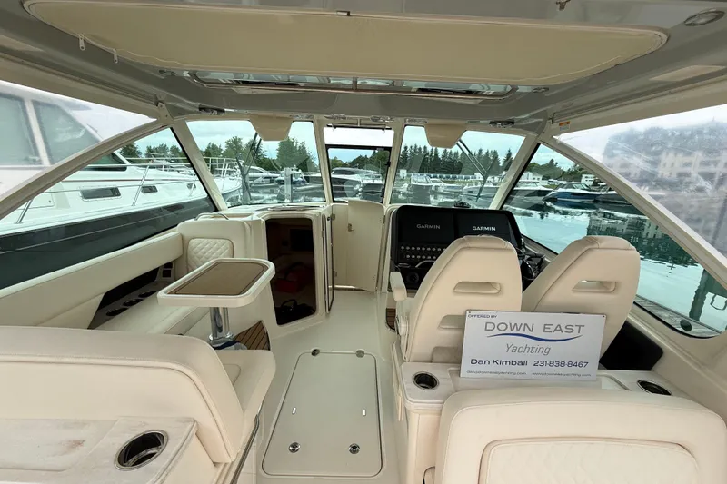 Slide: The Image of Interior of 2025 Grady-White Freedom 345 yacht, featuring luxurious seating and navigation equipment. - 16