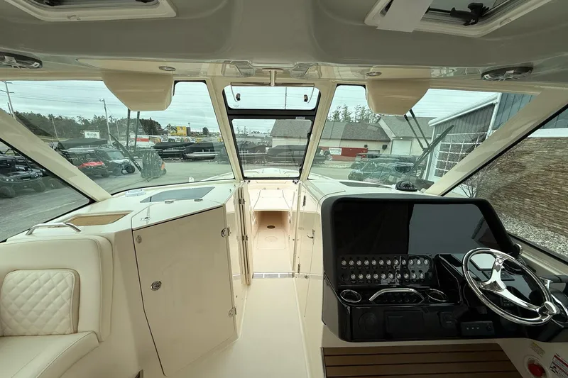 Slide: The Image of Interior view of 2025 Grady-White Freedom 345 boat cockpit with modern controls and seating. - 17