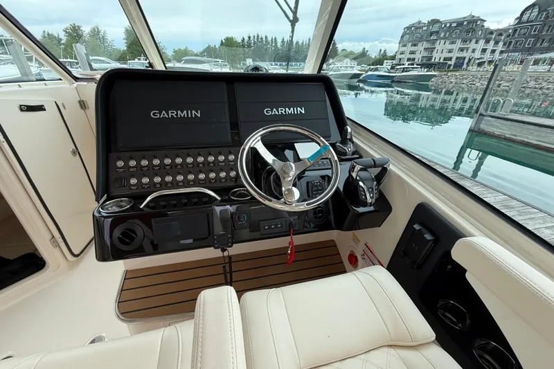 Slide: The Image of Helm of 2025 Grady-White Freedom 345 boat with Garmin navigation displays. - 19