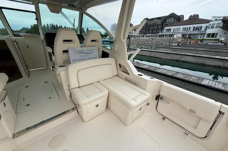 Slide: The Image of 2025 Grady-White Freedom 345 boat interior with luxurious seating at a marina. - 21