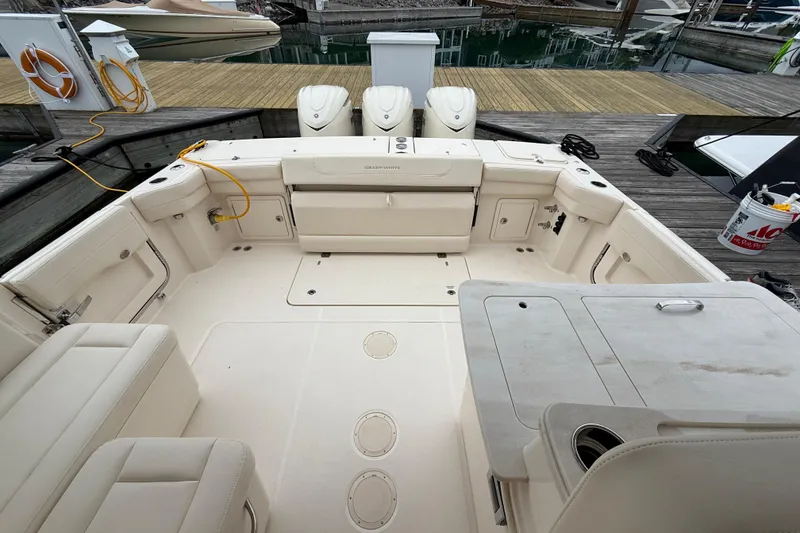 Slide: The Image of Spacious deck of 2025 Grady-White Freedom 345 boat docked at marina. - 24