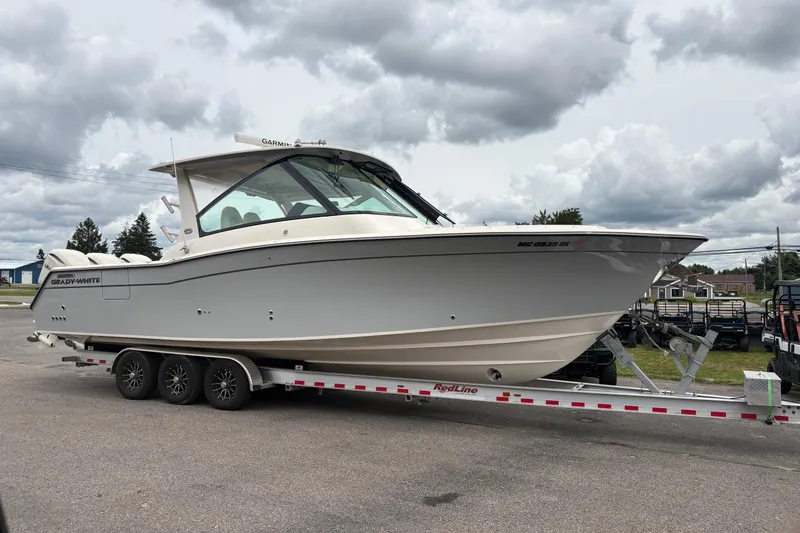 Slide: The Image of 2025 Grady-White Freedom 345 boat on trailer under cloudy sky. - 7