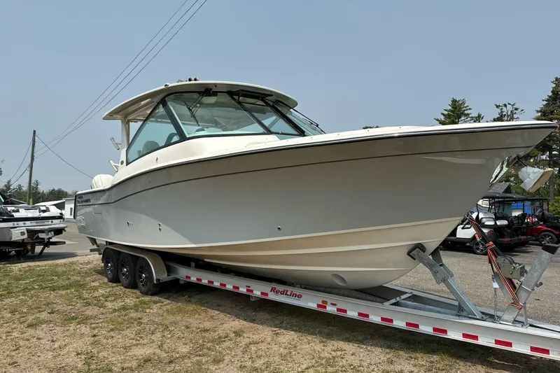 Slide: The Image of 2025 Grady-White Freedom 345 boat on trailer, parked outdoors. - 8