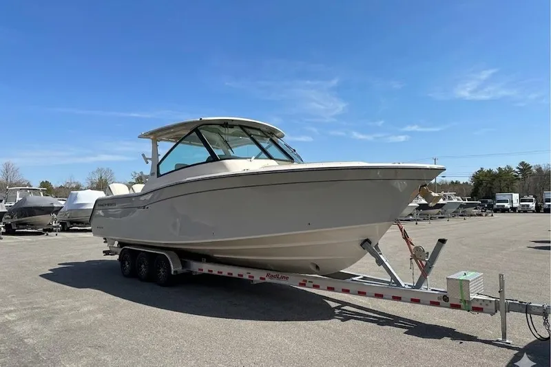 Slide: The Image of 2025 Grady-White Freedom 345 boat on trailer under clear blue sky. - 9