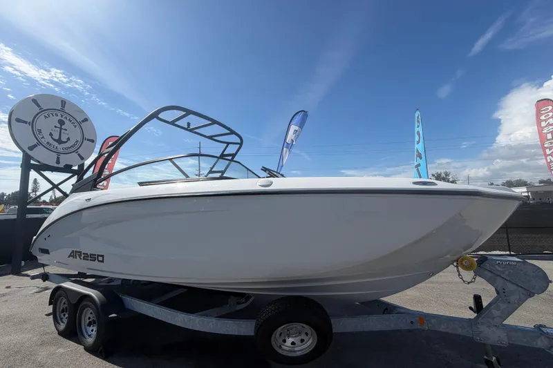 The Image of 2024 Yamaha Boats AR250 on trailer under clear blue sky. - 0