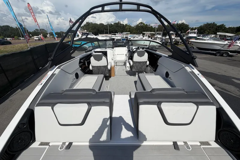 Slide: The Image of 2024 Yamaha Boats AR250 interior with seating and helm, displayed at a boat show. - 10