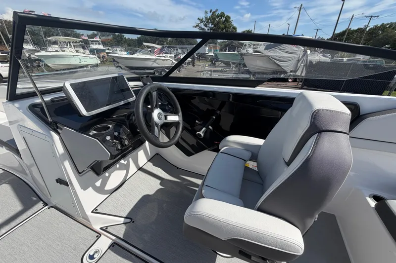 Slide: The Image of 2024 Yamaha Boats AR250 cockpit with modern steering and navigation system. - 13