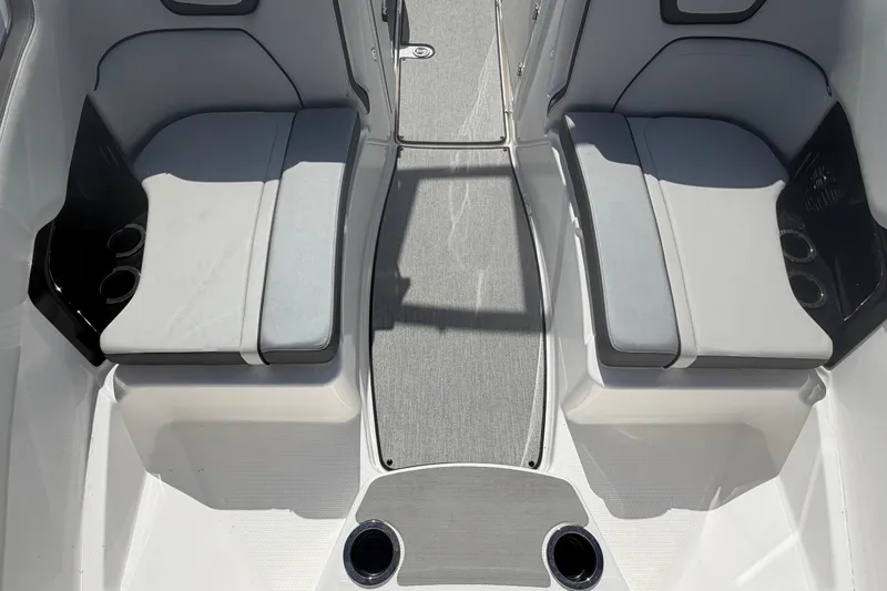 Slide: The Image of 2024 Yamaha Boats AR250 interior seating with cup holders and gray upholstery. - 18