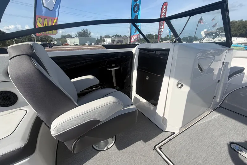 Slide: The Image of 2025 Yamaha Boats AR250 interior with captain's chair and dashboard, showcasing modern design. - 27