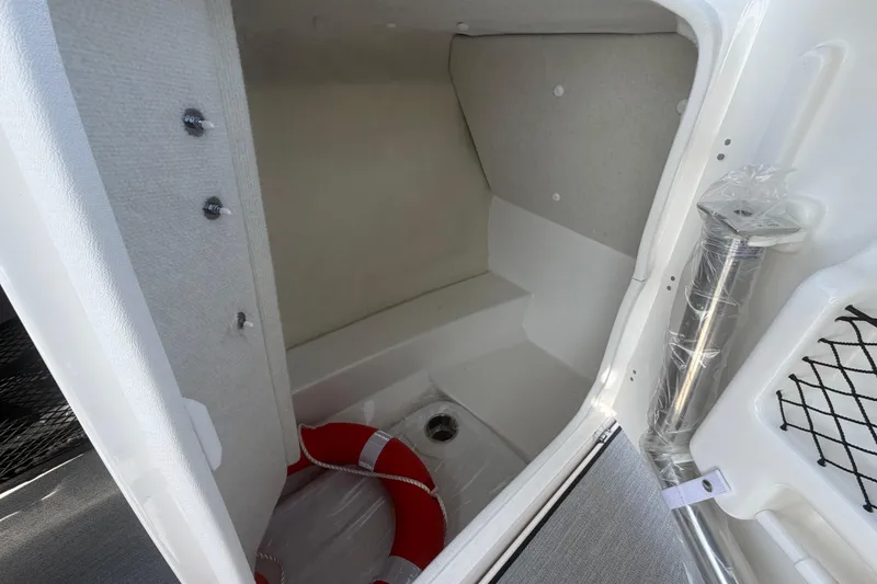 Slide: The Image of Interior storage compartment of 2025 Yamaha Boats AR250 with life preserver. - 31