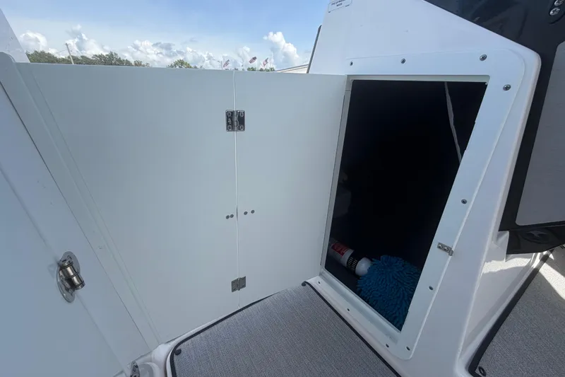 Slide: The Image of Open storage compartment on 2025 Yamaha Boats AR250, showcasing interior space and accessories. - 33