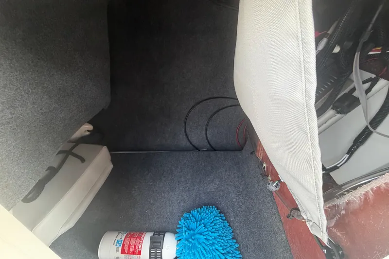 Slide: The Image of Interior storage compartment of 2025 Yamaha Boats AR250 with safety equipment. - 34