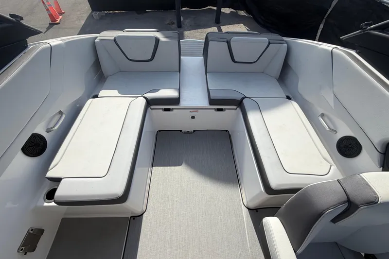 Slide: The Image of 2025 Yamaha Boats AR250 interior seating with gray upholstery and modern design. - 45