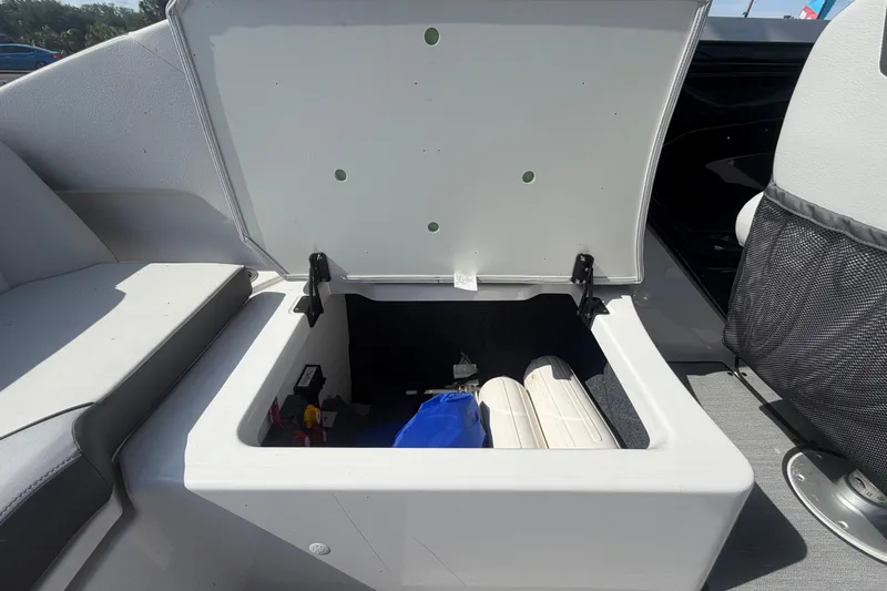 Slide: The Image of Open storage compartment in 2025 Yamaha AR250 boat, showcasing interior space and equipment. - 48