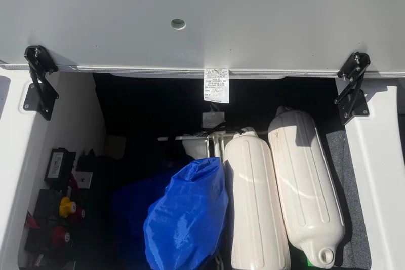 Slide: The Image of Storage compartment of 2025 Yamaha AR250 boat with fenders and gear. - 49