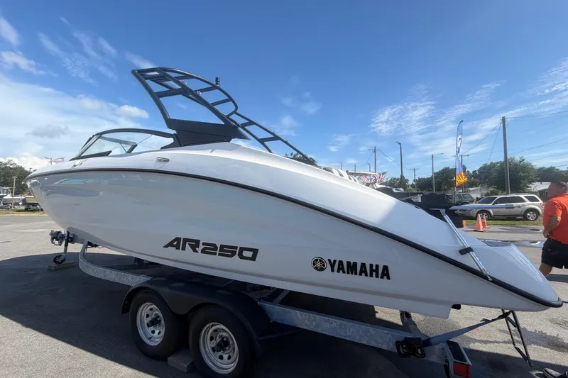 Slide: The Image of 2024 Yamaha Boats AR250 on trailer under clear blue sky. - 5
