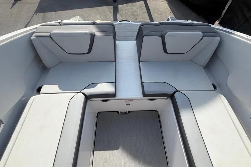 Slide: The Image of 2025 Yamaha Boats AR250 interior seating with gray upholstery and spacious layout. - 51