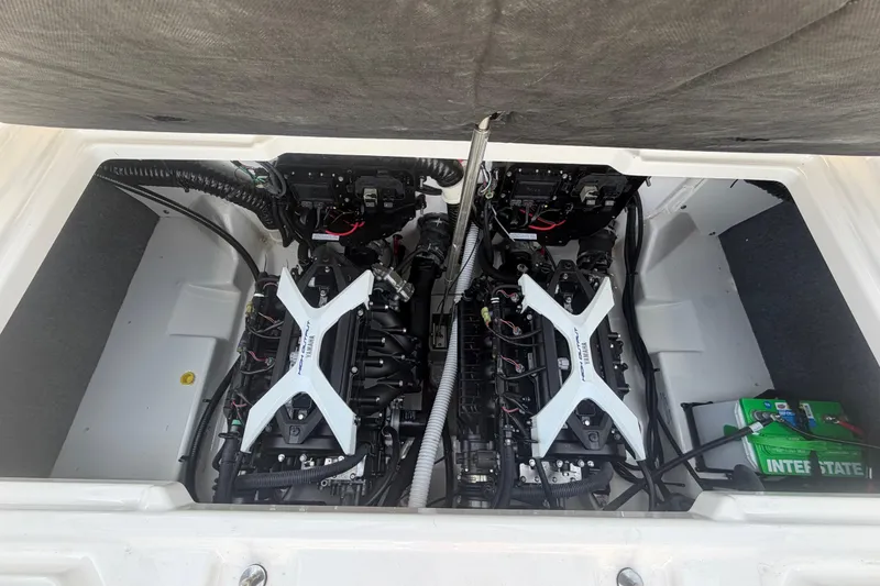 Slide: The Image of Engine compartment of a 2025 Yamaha Boats AR250, showcasing dual engines and battery setup. - 53