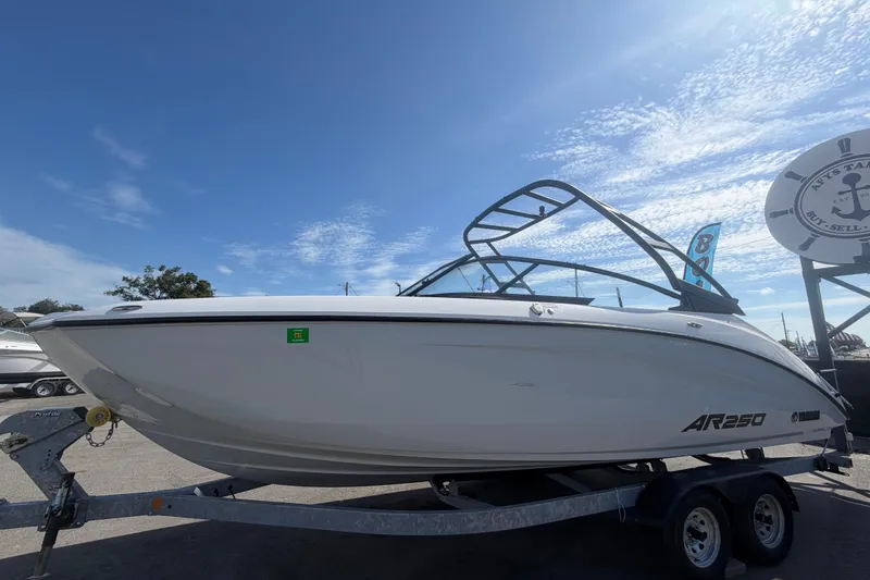Slide: The Image of 2024 Yamaha Boats AR250 on trailer under clear blue sky. - 7