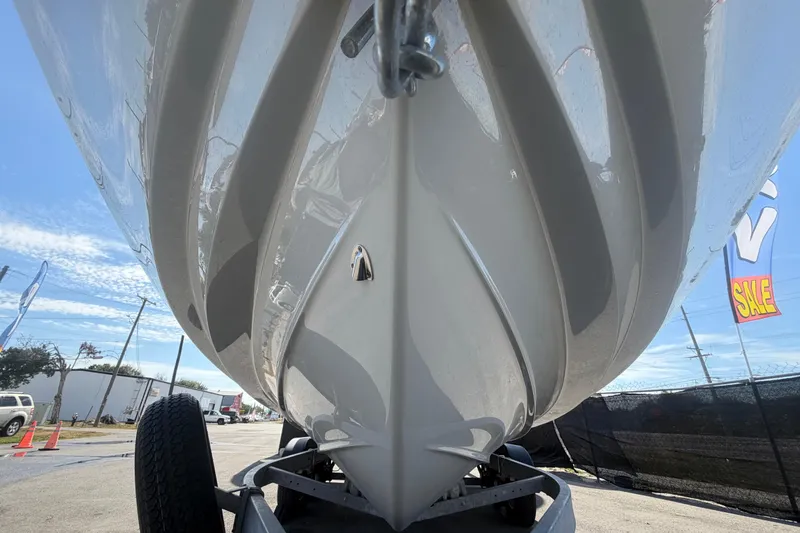 Slide: The Image of 2024 Yamaha Boats AR250 hull close-up, displayed on a trailer under a clear sky. - 9