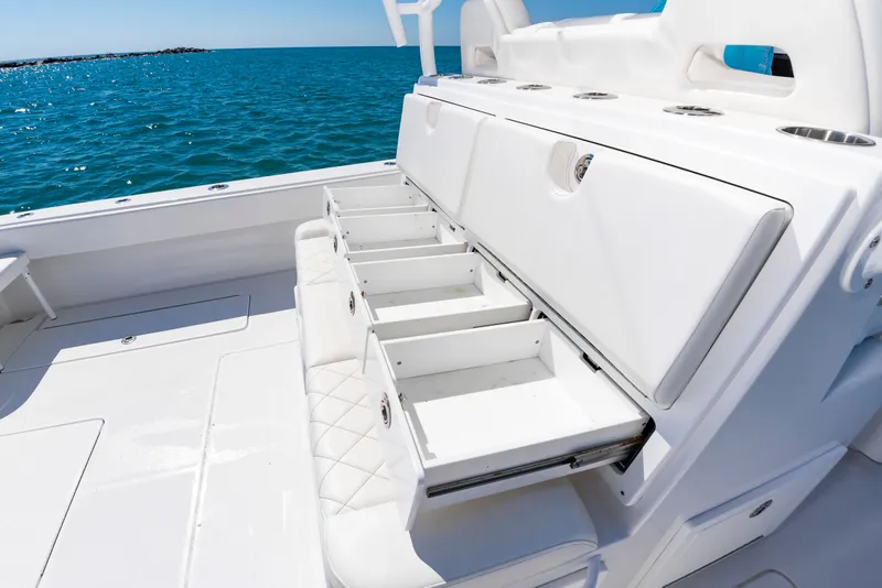 Slide: The Image of Onslow Bay 41 boat with open storage compartments on the water. - 27