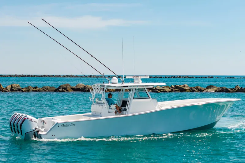 Slide: The Image of Onslow Bay 41 boat 2023 on blue water near rocks. - 49