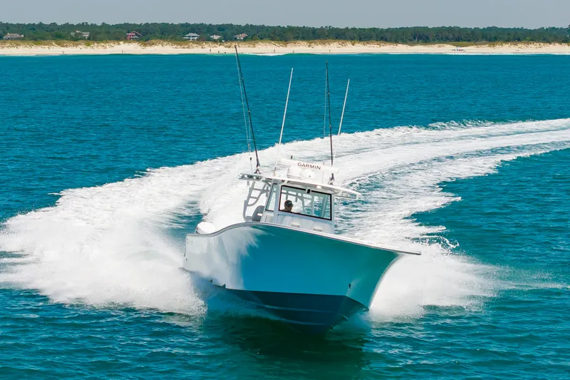 Slide: The Image of Onslow Bay 41 boat 2023 cruising on blue water near coast. - 7