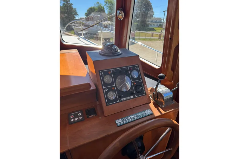 Slide: The Image of Pilothouse interior of 1998 Pacific Seacraft Pilothouse 32, featuring navigation instruments and controls. - 24