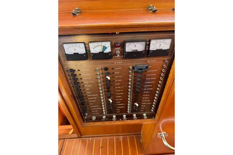 Slide: The Image of Electrical panel of a 1998 Pacific Seacraft Pilothouse 32 sailboat, featuring gauges and switches. - 25