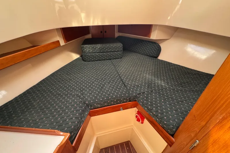 Slide: The Image of Cozy cabin interior of 1998 Pacific Seacraft Pilothouse 32 with cushioned V-berth. - 34