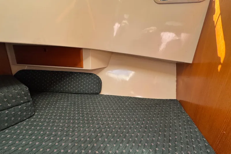 Slide: The Image of Interior cabin of 1998 Pacific Seacraft Pilothouse 32 with cushioned seating. - 37