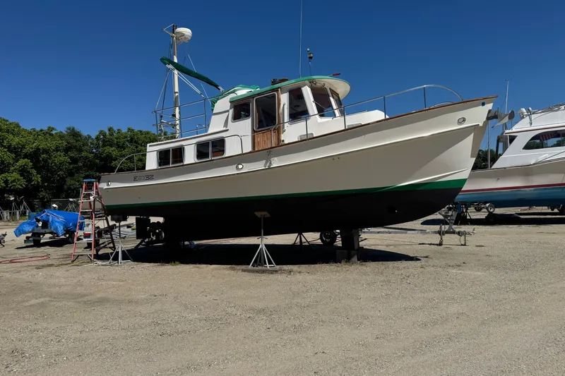 Slide: The Image of 1998 Pacific Seacraft Pilothouse 32 sailboat on dry dock, clear sky background. - 4