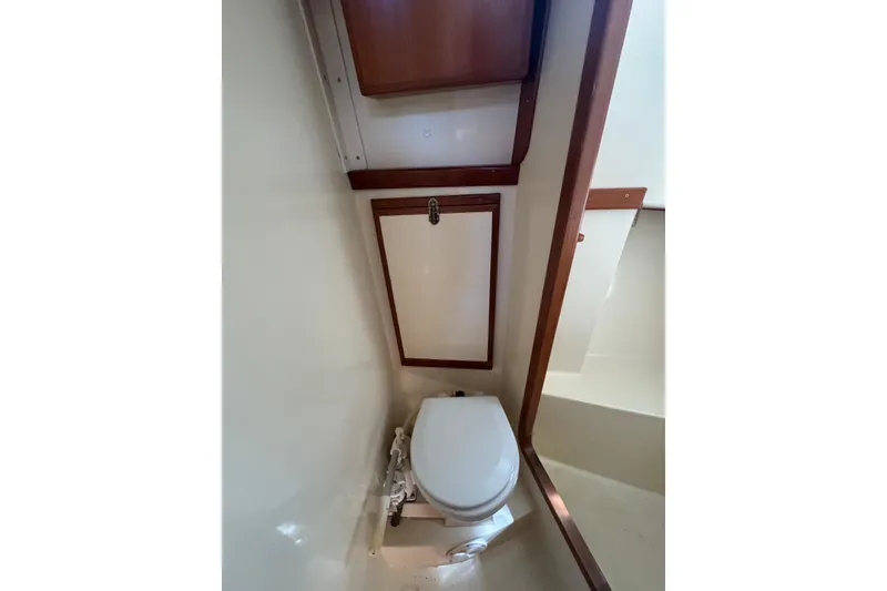 Slide: The Image of Compact bathroom in 1998 Pacific Seacraft Pilothouse 32 yacht, featuring a marine toilet. - 42