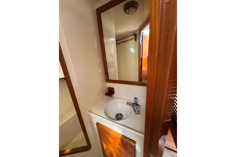 Slide: The Image of Compact bathroom in 1998 Pacific Seacraft Pilothouse 32 yacht with sink and mirror. - 43