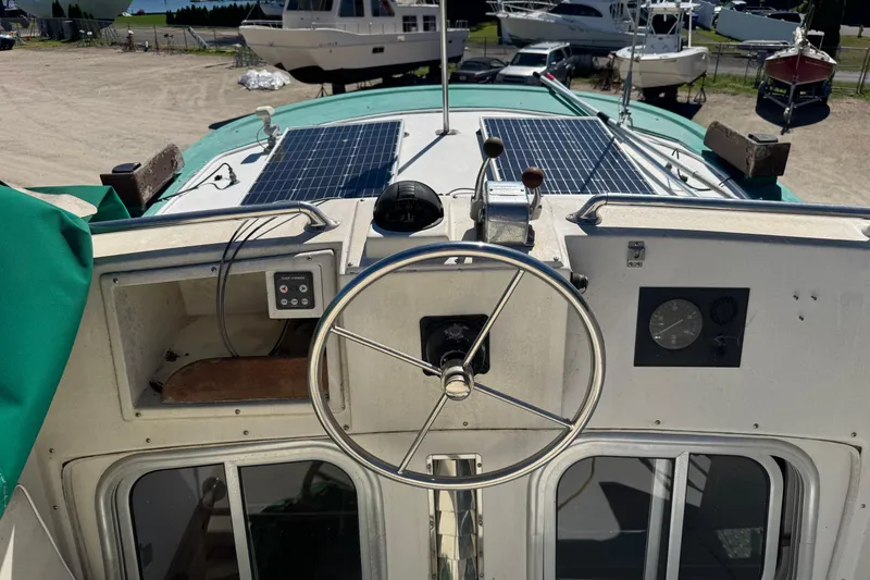 Slide: The Image of 1998 Pacific Seacraft Pilothouse 32 cockpit with steering wheel and solar panels. - 8